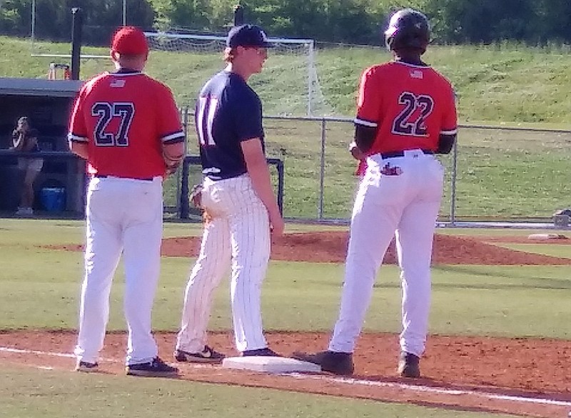 Team USA members Cole Wilcox (11) of Heritage High School and Kumar Rocker (22) of North Oconee chat at first base during Heritage's game two win over North Oconee in a GHSA Class AAAA state playoff second-round series Thursday in Ringgold, Ga.