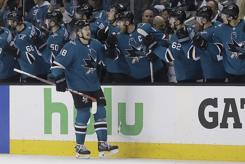 San Jose Sharks center Tomas Hertl, foreground, from the Czech Republic, is congratulated by teammates after scoring a goal against the Vegas Golden Knights during the second period of Game 4 of an NHL hockey second-round playoff series in San Jose, Calif., Wednesday, May 2, 2018. (AP Photo/Jeff Chiu)