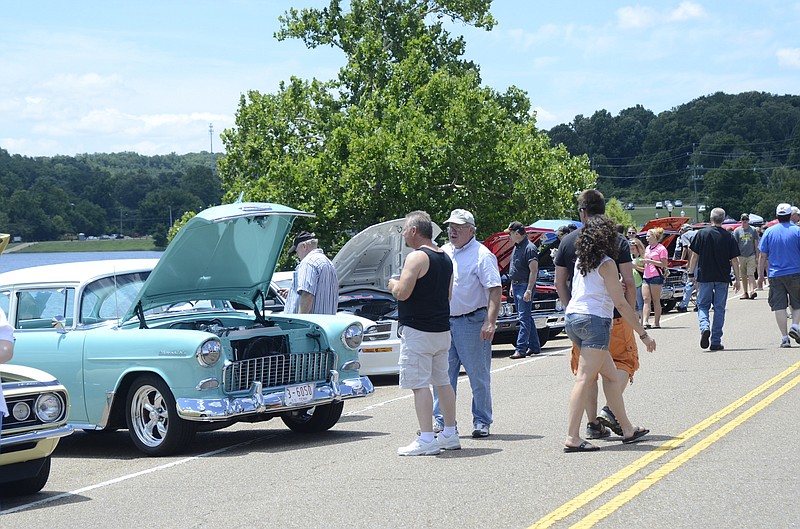 People gather to look at vintage vehicles at the Fourth of July festivities at North Park across from Soddy Lake.