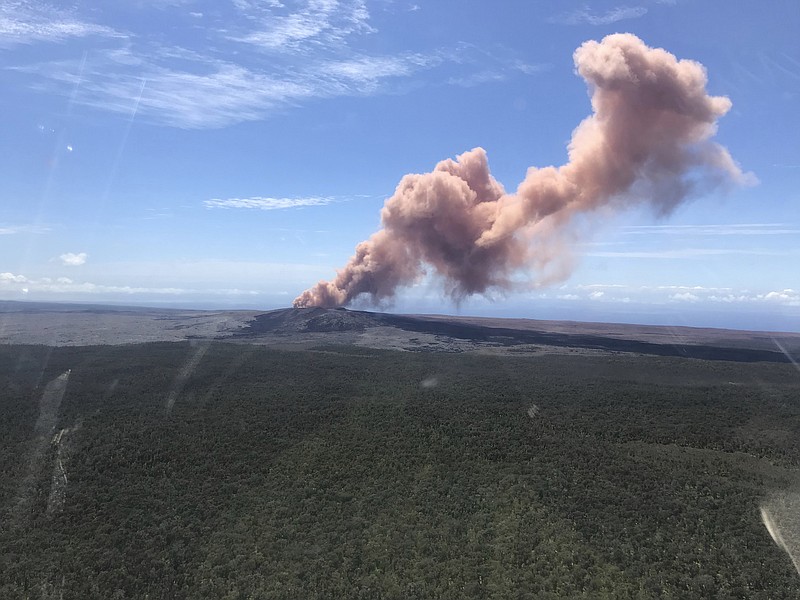 In this photo provided by the U.S. Geological Survey, red ash rises from the Puu Oo vent on Hawaii's Kilauea Volcano after a magnitude-5.0 earthquake struck the Big Island, Thursday, May 3, 2018 in Hawaii Volcanoes National Park. The temblor Thursday is the latest and largest in a series of hundreds of small earthquakes to shake the island's active volcano since the Puu Oo vent crater floor collapsed and caused magma to rush into new underground chambers on Monday. Scientists say a new eruption in the region is possible. (Kevan Kamibayashi/U.S. Geological Survey via AP)