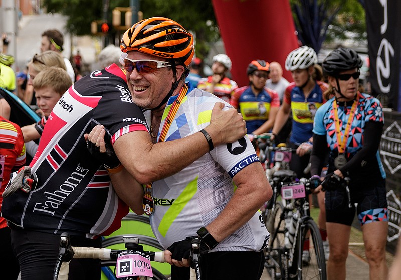 Carl Druiz, left, hugs Ken Matthews after they finished the Gran Fondo Hincapie cycling event in front of the Bessie Smith Cultural Center on Saturday, May 5, 2018, in Chattanooga, Tenn. 1160 riders participated in the event which this year expanded from Greenville, S.C. to Chattanooga.