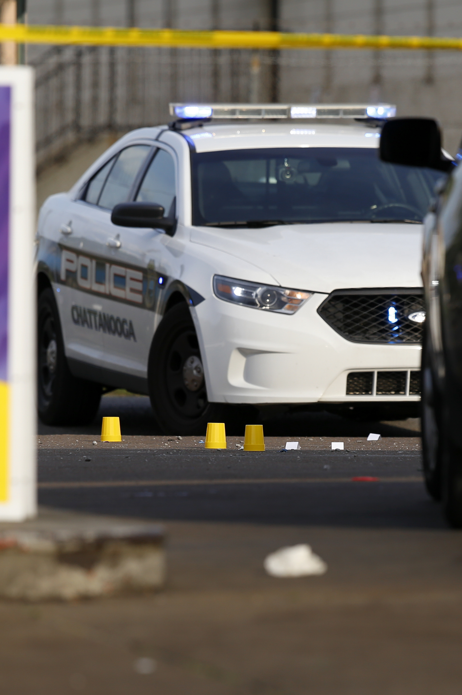 Evidence markers mark locations on the ground at the scene of a fatal shooting outside of Nine Brothers convenience store at the intersection of Central Avenue and West 38th Street on Sunday, May 6, 2018 in Chattanooga, Tenn.