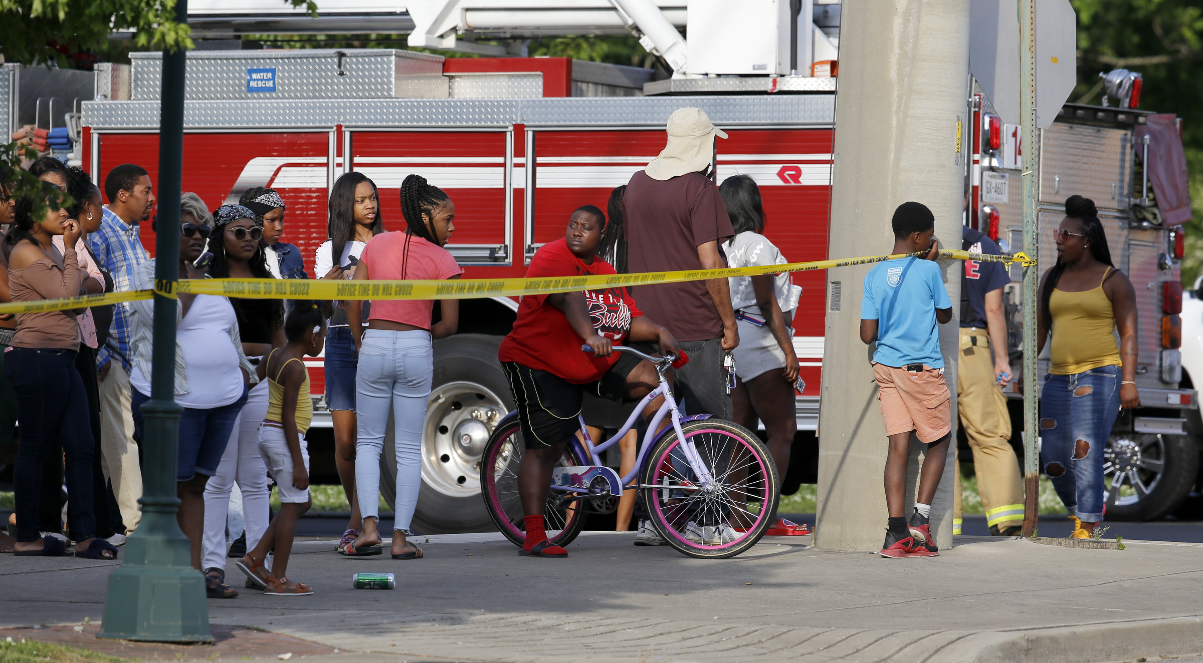 People look on as police investigate a fatal shooting at the intersection of Central Avenue and West 38th Street on Sunday, May 6, 2018 in Chattanooga, Tenn.