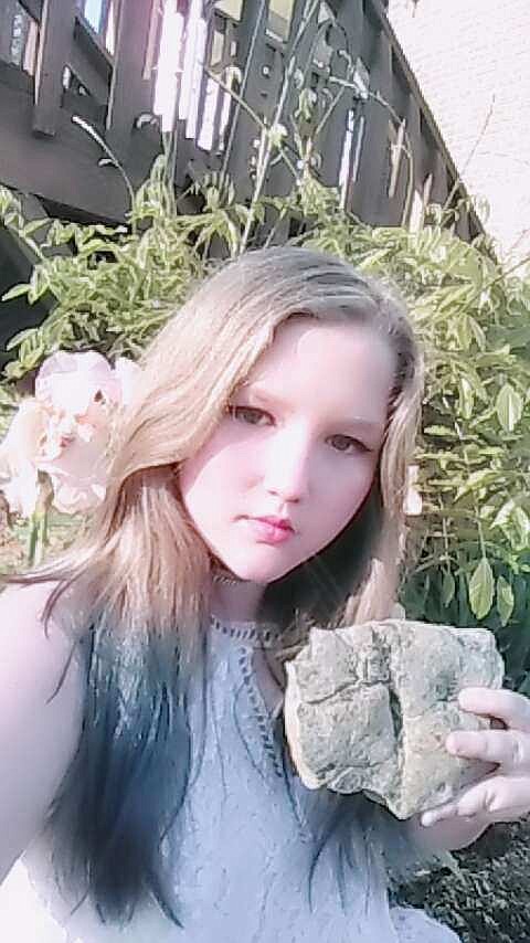 Ryleigh Taylor, 11, poses with the fossil she discovered. 