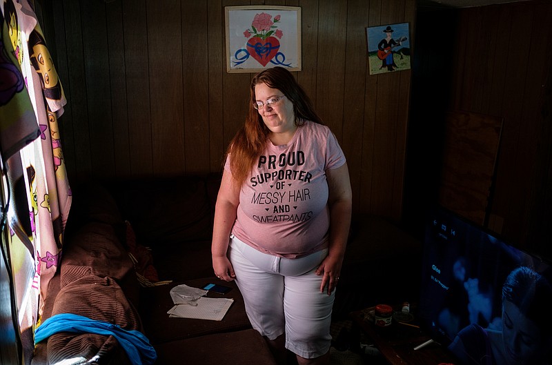 Kaylynn Sanchez-Miguel stands in the living room of the trailer she shares with her husband David in the Blue Ridge Estates trailer park on Wednesday, May 2, 2018, in Rossville, Ga. Sanchez-Miguel lives in the trailer under a lease with option to purchase agreement where residents are responsible for repairing and maintaining the trailer they are leasing, but she says numerous serious problems with the trailer's structure and electrical functions existed when they moved in.