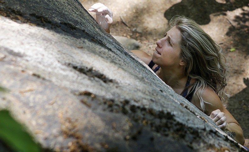 Katherine Vanderford tries to make her way up a boulder while climbing at Stone Fort, also known as Little Rock City, on Sunday, May 6, 2018 in Soddy-Daisy, Tenn. To coincide with the opening of their new Chattanooga store on May 18, REI sponsored a weekend of outdoor activities including free entrance to Stone Fort/Little Rock City.