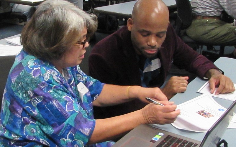 Chattanooga State student John Jones helps a senior learn to use a computer during the college's first Cyber Seniors program held in December. (Contributed photo)