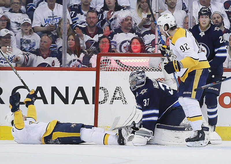 
              Nashville Predators' Filip Forsberg (9) and Ryan Johansen (92) celebrate Forsberg's goal against Winnipeg Jets goaltender Connor Hellebuyck (37) during second period NHL hockey playoff action in Winnipeg, Manitoba, Monday, May 7, 2018. (John Woods/The Canadian Press via AP)
            