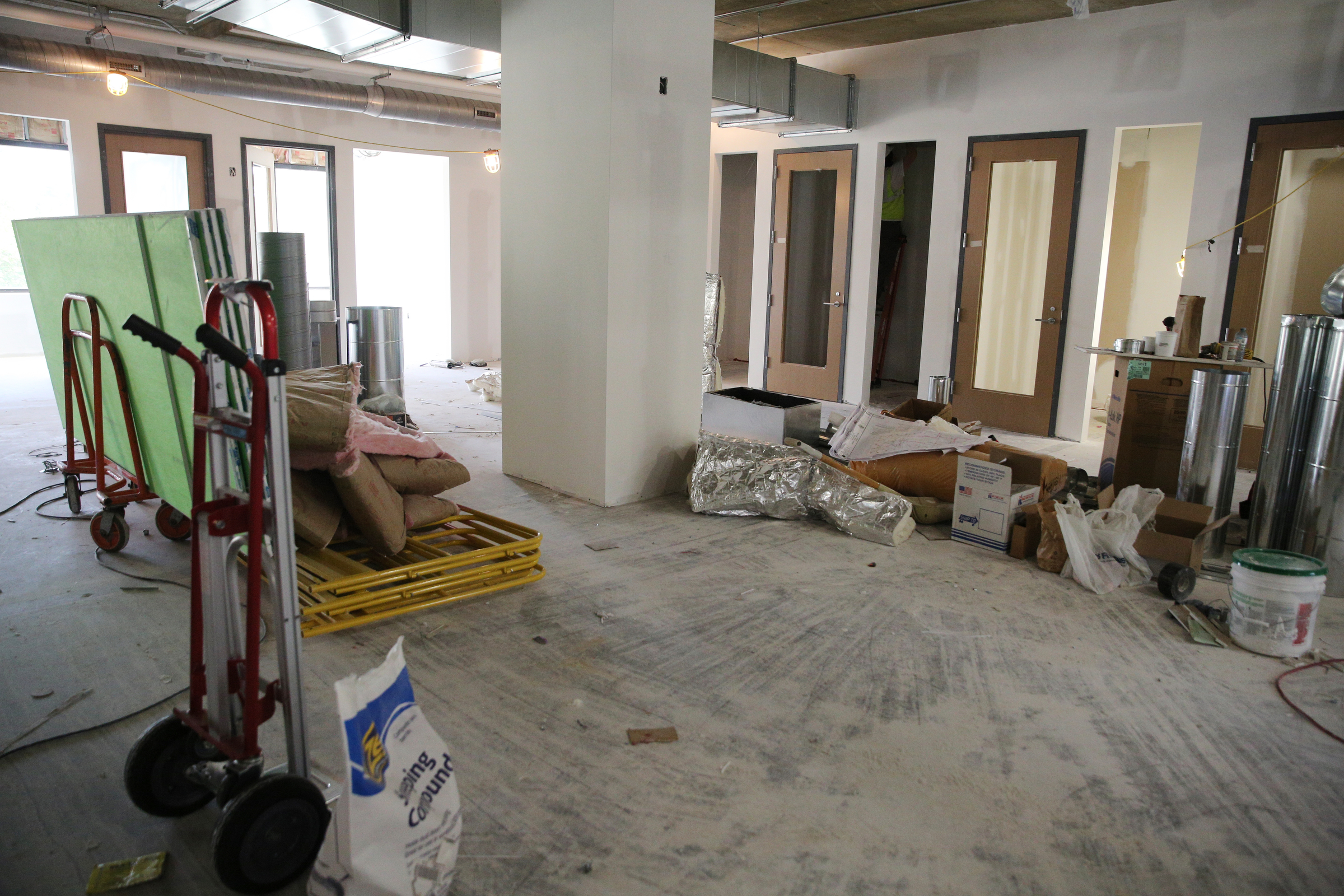 A common area is filled with equipment as construction is underway at E/SPACES Wednesday, May 2, 2018 in Chattanooga, Tenn. E/SPACES is located inside University Tower on 4th Street.