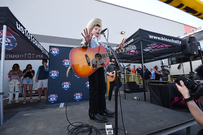 Mason Ramsey plays to a huge parking lot crowd Wednesday evening, May 9, 2018, at the Gunbarrel Walmart.