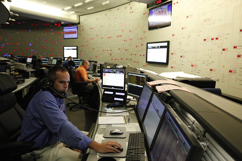 Staff Photo by Doug Strickland/Chattanooga Times Free Press - June 29, 2012.  Transportation operator Jason Baggett works at a computer station in the TVA System Operations Center at TVA headquarters in Chattanooga, Tenn. on Friday.  Several days of temperatures above 100 degrees will push TVA's power demands over the weekend.