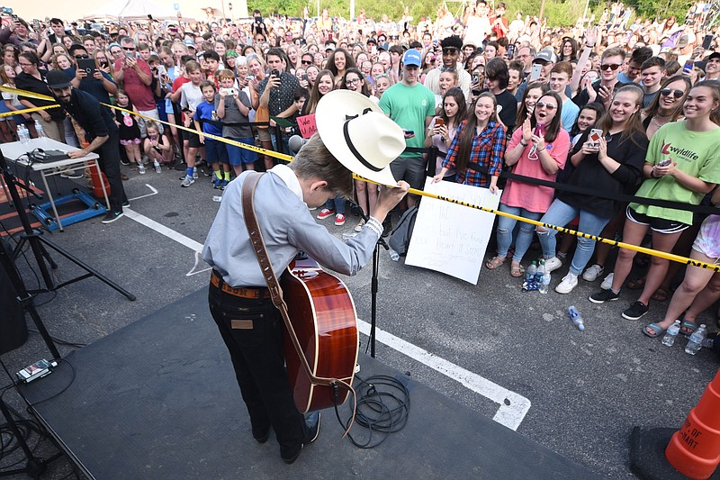 Yodeler Mason Ramsey tips his hat to a huge crowd Wednesday evening in the Gunbarrel Walmart parking lot. The 11-year-old has gone viral on the web in recent days. Birmingham is his next performance.
