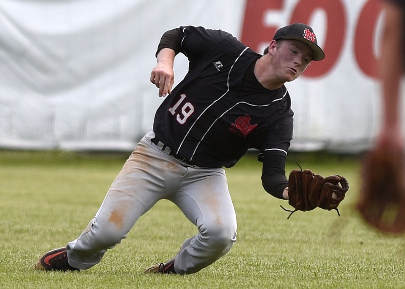 Signal Mountain center fielder, Scott Payne (19) goes to the grass as he catches a short Hixson flyball for a out.  The Signal Mountain Eagles met the Hixson Wildcats in the District 6-AA baseball championship at Red Bank High on May 9, 2018