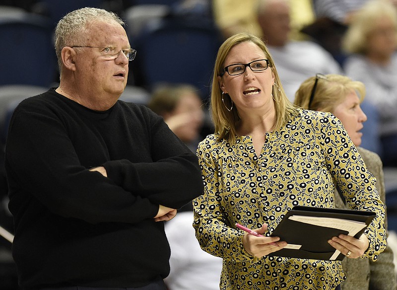 Katie Burrows, right, and Jim Foster talk during a UTC women's basketball game this past season. Foster, the Mocs' head coach the past five seasons, retired Tuesday, with Burrows taking over the program on an interim basis.