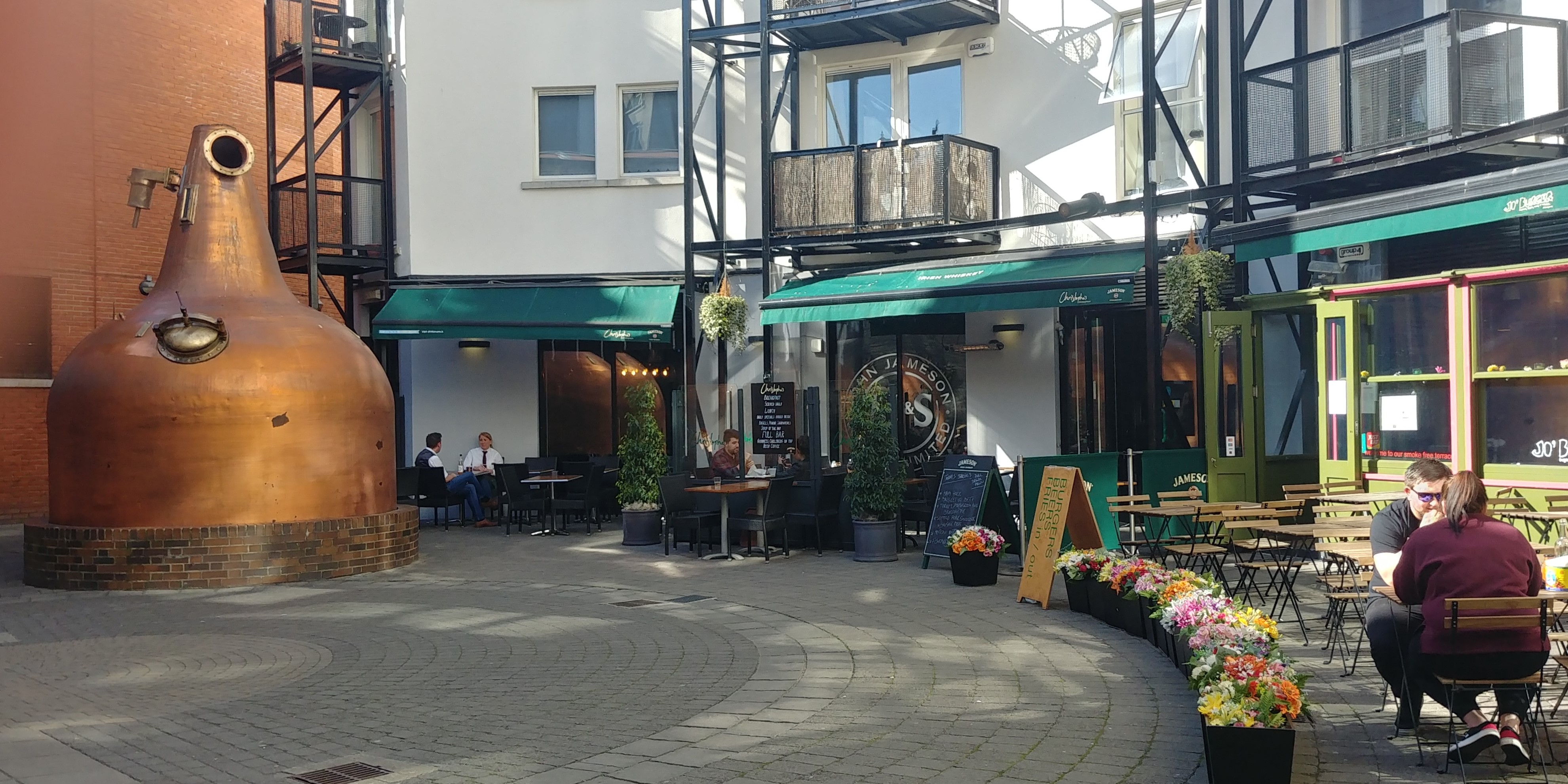 The courtyard outside Jameson Whiskey has cafes and bars, where visitors may enjoy a bite to eat along with a jigger of the famous Irish whiskey. (Photo by Anne Braly)