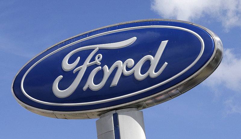 FILE - This Jan. 17, 2017, file photo shows a Ford sign at an auto dealership, in Hialeah, Fla. There’s no apparent signs that Wall Street is worried about a plant fire that is forcing Ford to cut back on production of its F-150 pickup, the top-selling vehicle in America. The company suspended F-150 and Super Duty production in several cities. (AP Photo/Alan Diaz, File)