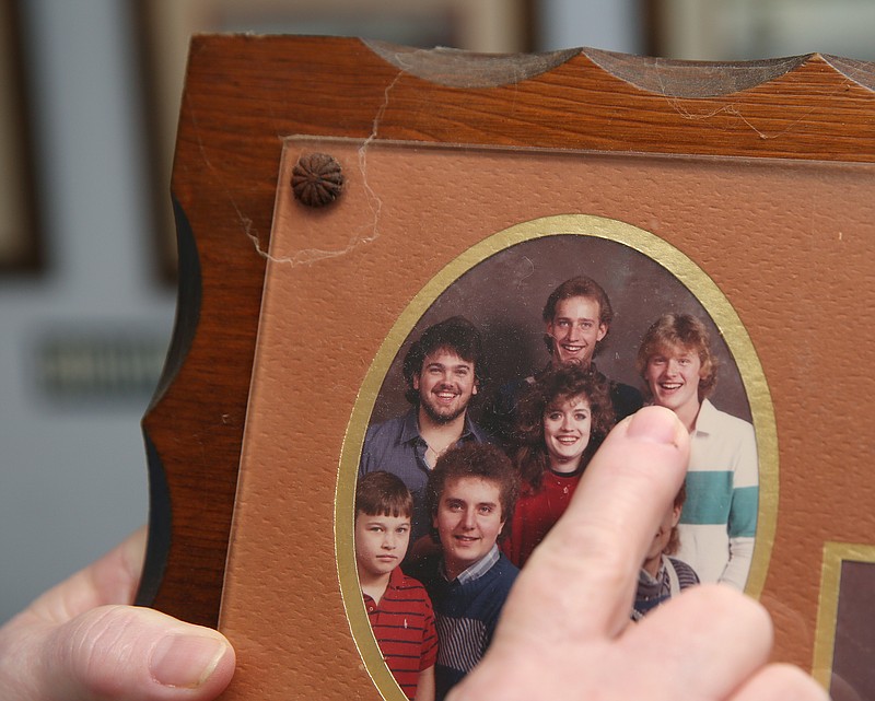 Staff photo by Erin O. Smith / Tina Simmons Honeycutt points out her brother, Jeffery Simmons, in and old family photo Thursday, March 15, 2018, in Fort Oglethorpe, Ga. Jeffery Simmons, 45, died in the Hamilton County Jail last year from a methamphetamine overdose.