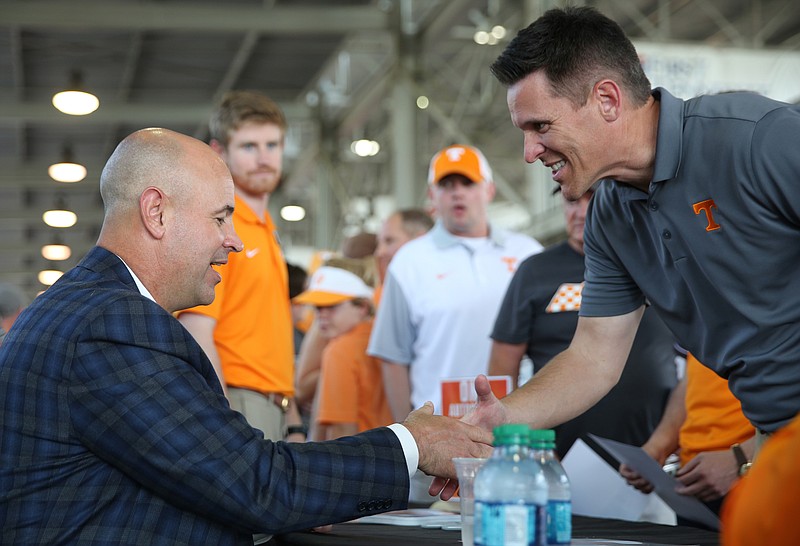 University of Tennessee head football coach Jeremy Pruitt shakes hands with Scott Rice during the Big Orange Caravan Thursday, May 10, 2018 at the Tennessee Pavilion in Chattanooga, Tenn. The Big Orange Caravan made its annual Chattanooga stop, and athletic director Phillip Fulmer, head football coach Jeremy Pruitt, basketball coach Rick Barnes, women's basketball coach Holly Warlick and others were in attendance to speak and sign autographs.