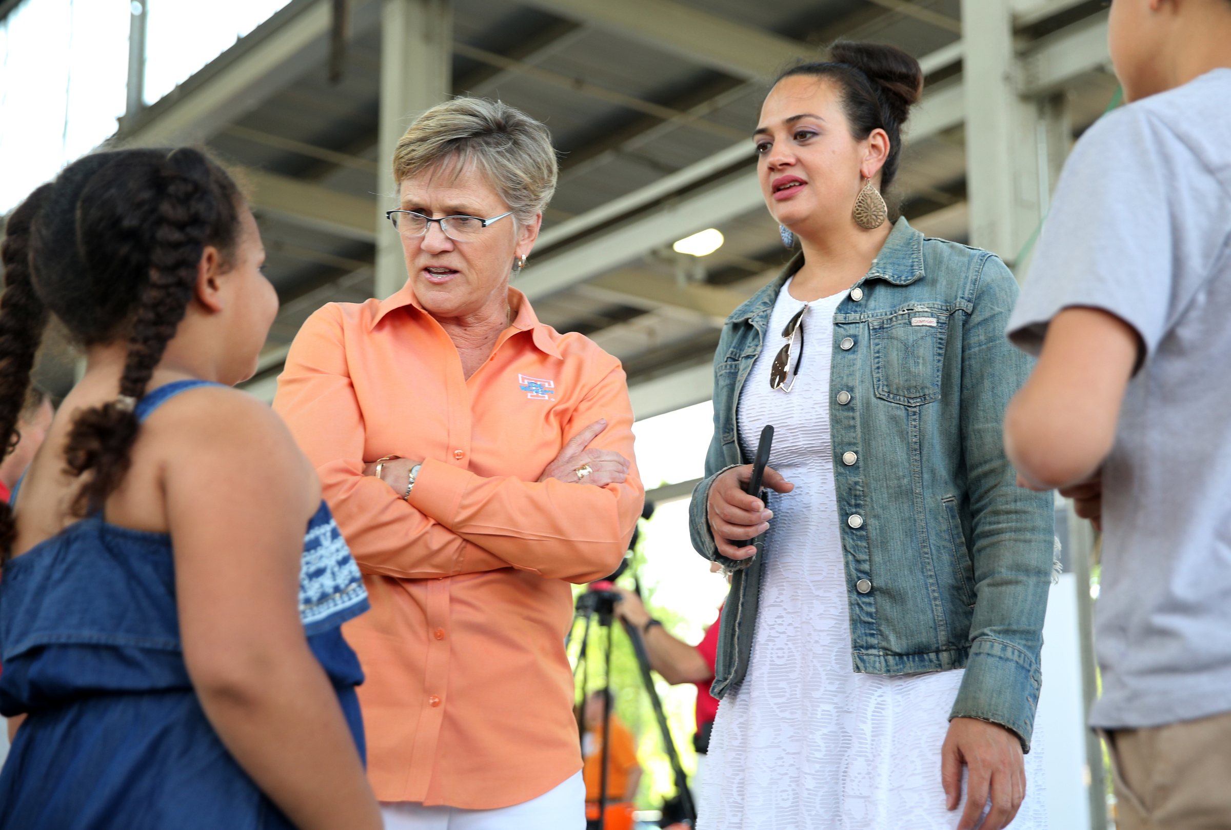 University of Tennessee women's basketball coach Holly Warlick, second from left, speaks with Teagan McClure, 7, Kristina McClure and Vincent McClure, 12, during the Big Orange Caravan Thursday, May 10, 2018 at the Tennessee Pavilion in Chattanooga, Tenn. A few hundred Vols fans made their way to the Tennessee Pavilion to get autographs from coaches and hear them speak.