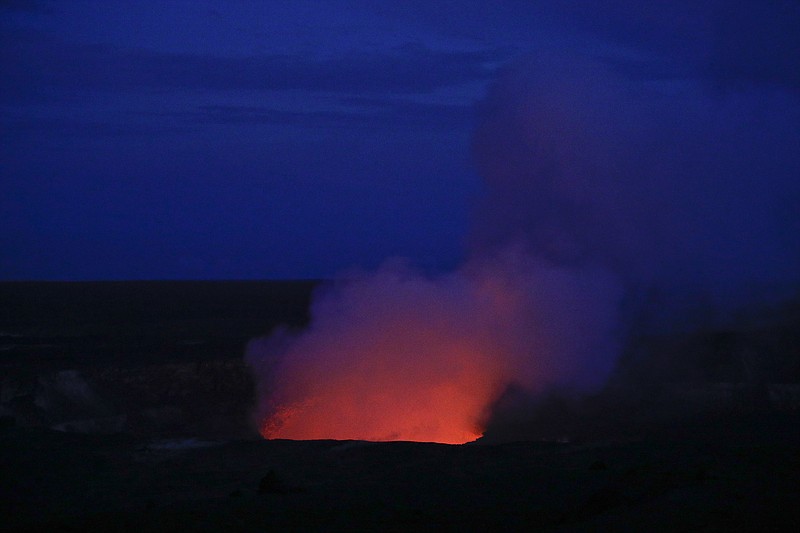 Kilauea's summit crater glows red in Volcanoes National Park, Hawaii, Wednesday, May 9, 2018. Geologists warned Wednesday that Hawaii's Kilauea volcano could erupt explosively and send boulders, rocks and ash into the air around its summit in the coming weeks. (AP Photo/Jae C. Hong)