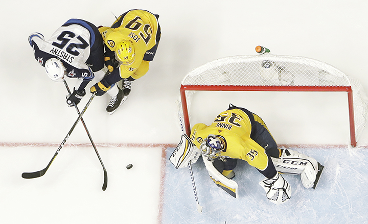 Winnipeg Jets center Paul Stastny (25) scores a goal between Nashville Predators defenseman Roman Josi (59), of Switzerland, and goalie Pekka Rinne (35), of Finland, during the first period in Game 7 of an NHL hockey second-round playoff series Thursday, May 10, 2018, in Nashville, Tenn. The Jets won 5-1 and advanced to the Western Conference final. (AP Photo/Mark Humphrey)