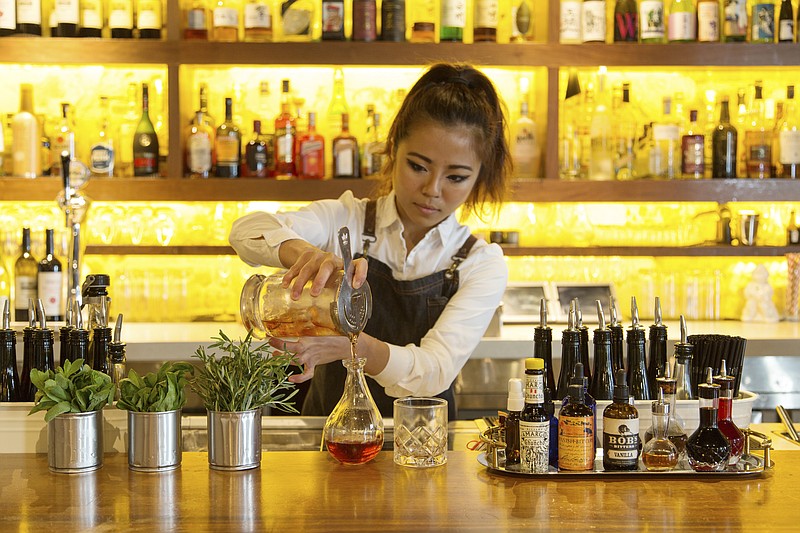 If you've yet to make your summer travel plans, several attractive international destinations are reachable at a discount. In Singapore, pour a cocktail at the Neon Pigeon. (Lauryn Ishak/The New York Times)