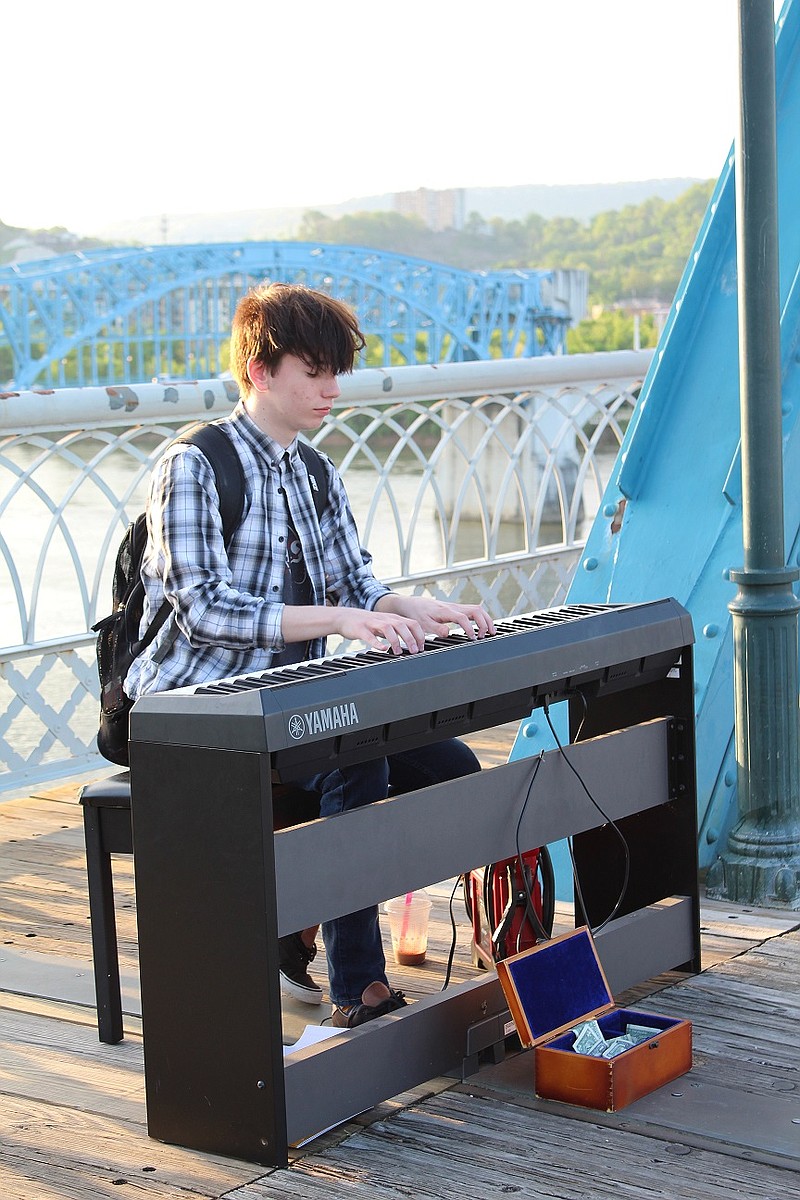 Chance Baggett performs on the Walnut Street Bridge at the end of April. (Contributed photo by Erin Rickman)