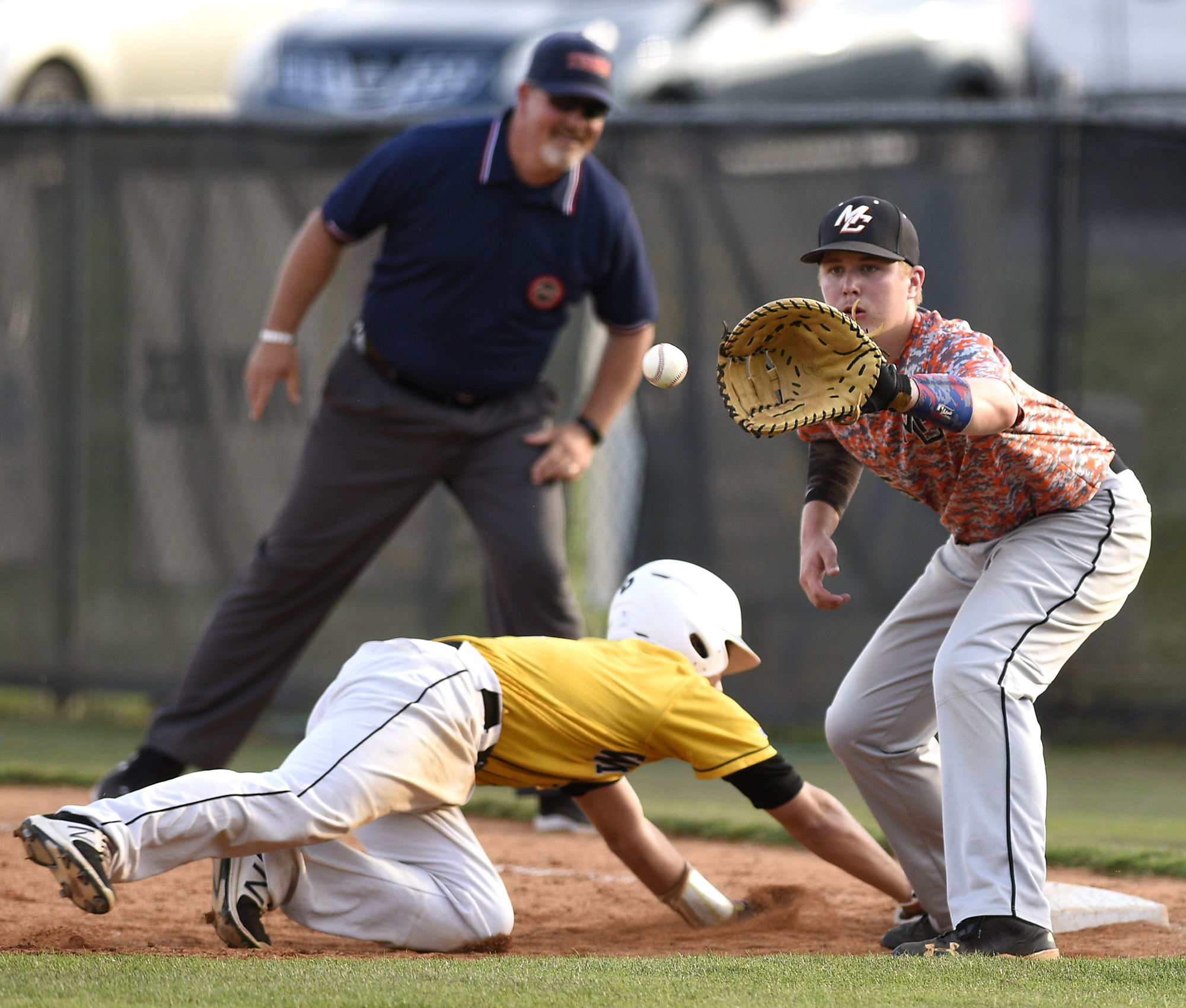 Hixson's Landon Wallace (1) beats a pickoff move back to first base as Meigs County's E.J. Beshears (5) takes the throw. The Meigs County Tigers visited the Hixson Wildcats in the TSSAA Region 3-AA baseball final on May 14, 2018.