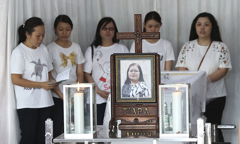 Family members pray during the wake for Marta Djumani, one of the victims of Sunday's church attacks, at a funeral home in Surabaya, East Java, Indonesia, Monday, May 14, 2018. The flurry of bombings raised concerns that previously beaten-down militant networks in the world's most populous Muslim-majority nation have been reinvigorated by the return of some of the estimated 1,100 Indonesians who went to fight with the Islamic State group in Syria. Experts have warned for several years that when those fighters return, they could pose a significant threat. (AP Photo/Achmad Ibrahim)