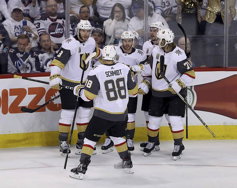 The Vegas Golden Knights' celebrate after Jonathan Marchessault (81) scored on Winnipeg Jets goaltender Connor Hellebuyck, not shown, during first period game 2 NHL Western Conference Finals hockey action in Winnipeg, Manitoba, Monday, May 14, 2018. (Trevor Hagan/The Canadian Press via AP)