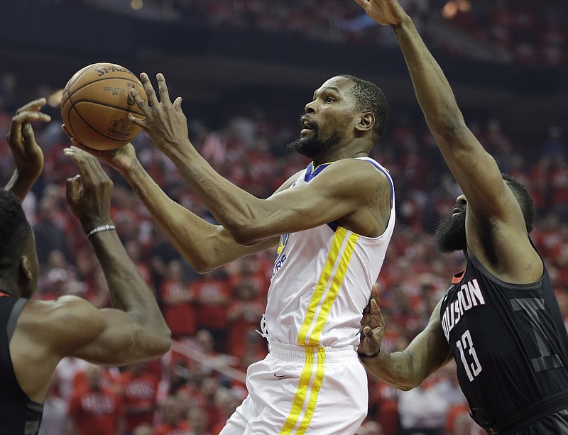 Golden State Warriors forward Kevin Durant (35) drives to the basket past Houston Rockets guard James Harden (13) during the first half of Game 1 of the NBA basketball Western Conference Finals, Monday, May 14, 2018, in Houston. (AP Photo/David J. Phillip)