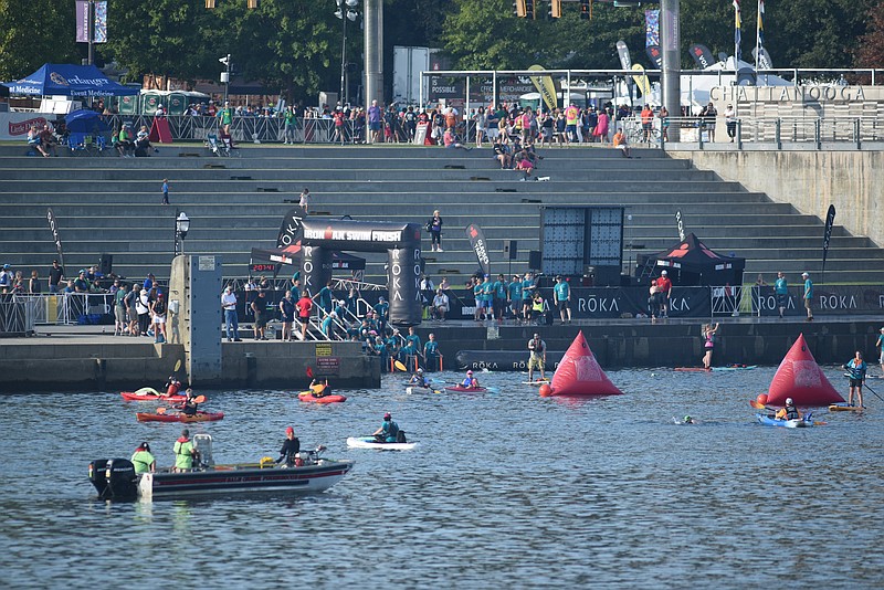 Swimmers arrive at Ross's Landing on the Tennessee River during the first leg of the 2017 Ironman 70.3 event. (Staff photo by Tim Barber)