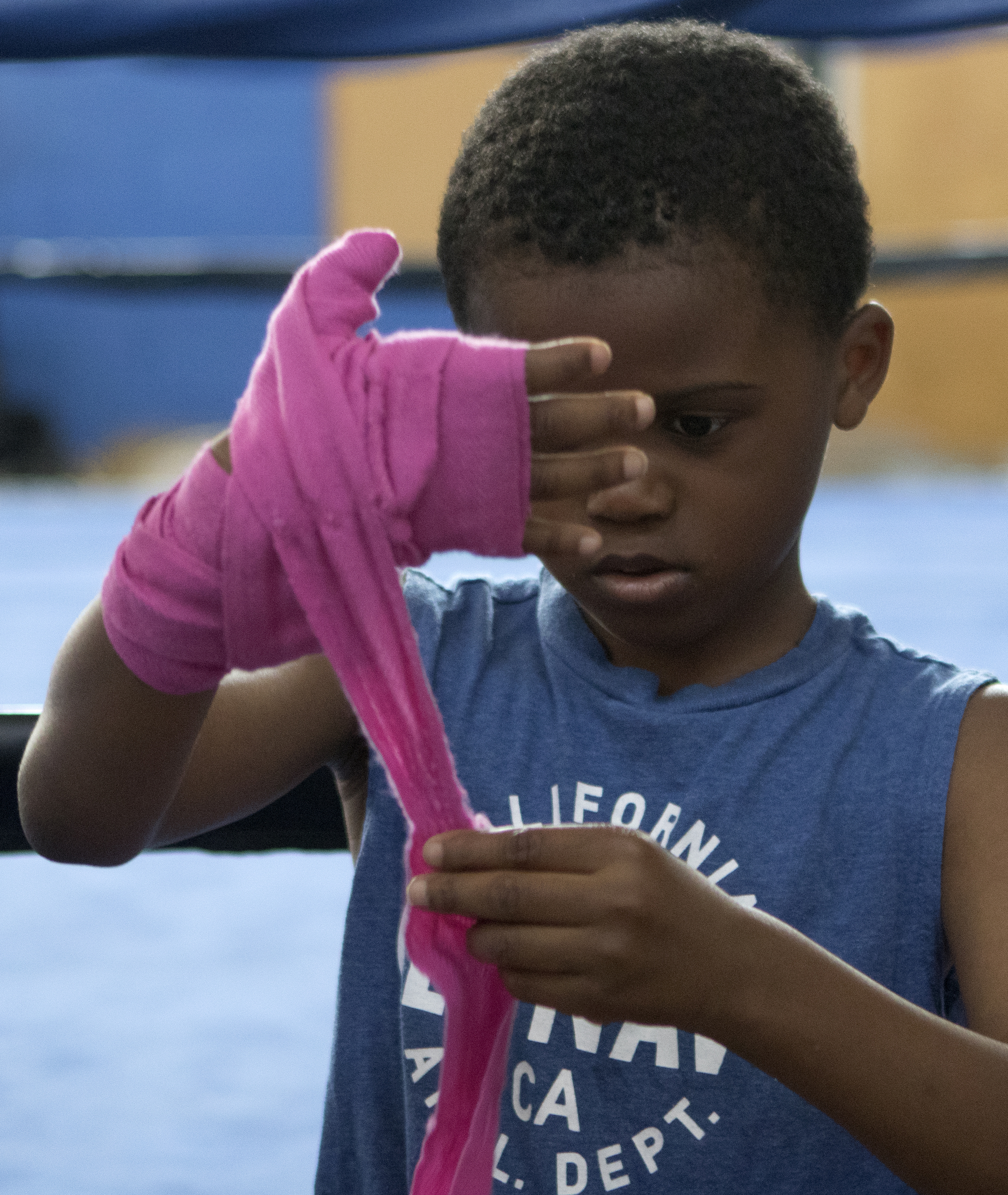 Eight-year-old Jaden Medley tapes his hand before training at the Westside boxing gym on Monday, May 14, 2018 in Chattanooga, Tenn.