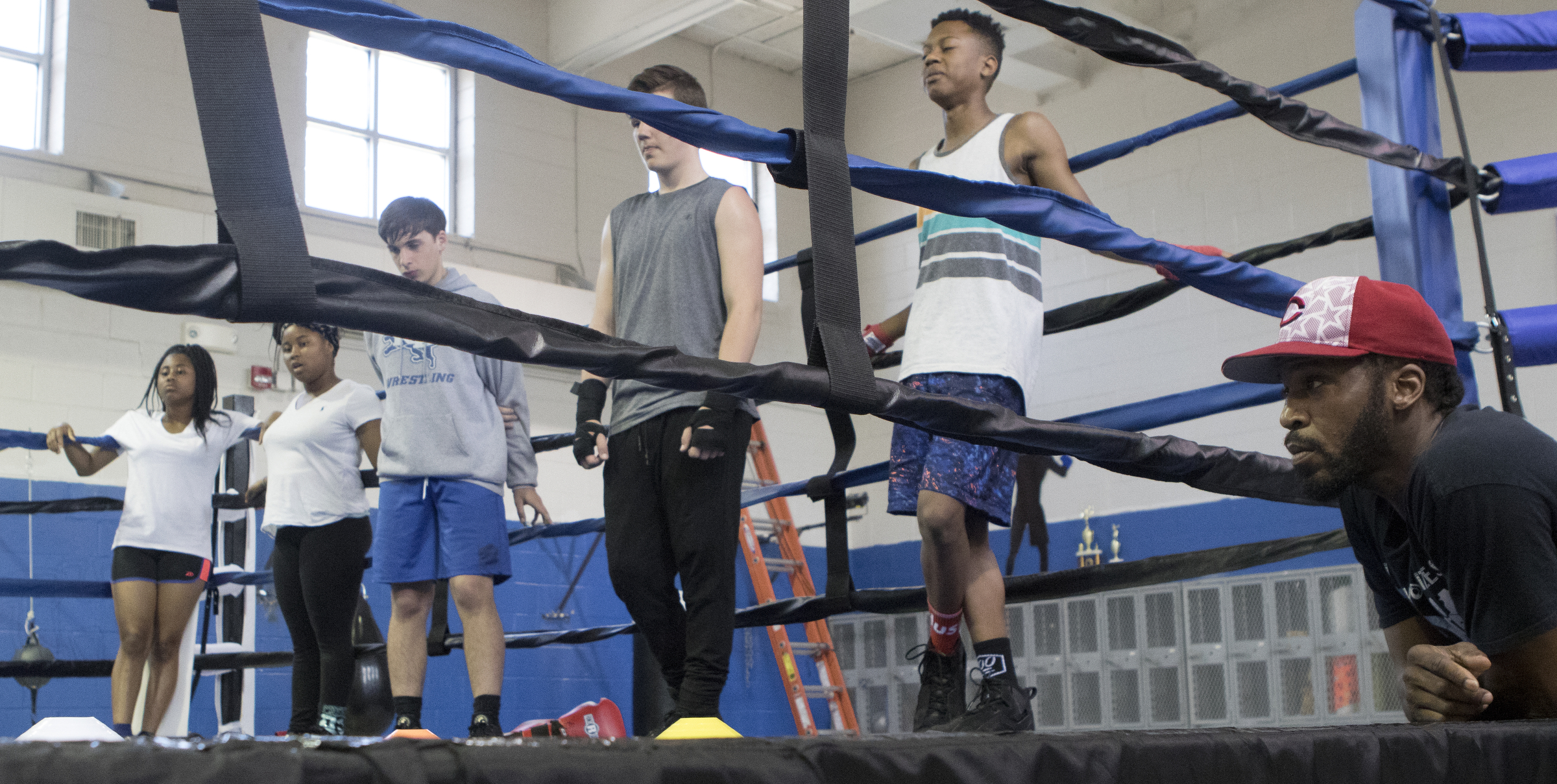 Mike Dawson, bottom right, looks on as boxers go through warm ups in the ring at the Westside boxing gym on Monday, May 14, 2018 in Chattanooga, Tenn.
