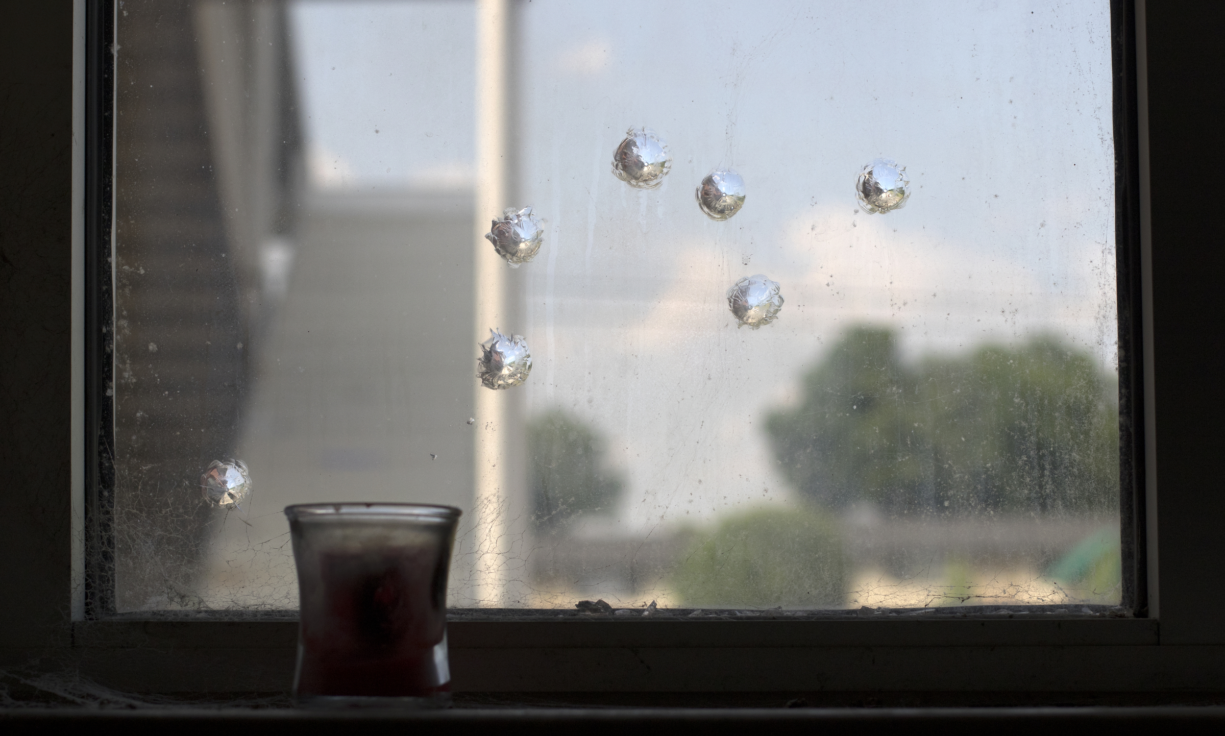Bullet impacts are seen on the window of the women's bathroom at the Westside boxing gym on Monday, May 14, 2018 in Chattanooga, Tenn.