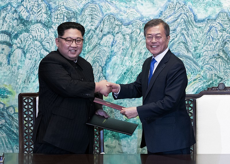 In this April 27, 2018 file photo, North Korean leader Kim Jong Un, left, and South Korean President Moon Jae-in shake hands after signing on a joint statement at the border village of Panmunjom in the Demilitarized Zone, South Korea. The two Koreas will hold a high-level meeting on Wednesday, May 16, 2018, to discuss setting up military and Red Cross talks aimed at reducing border tension and restarting reunions between families separated by the Korean War. (Korea Summit Press Pool via AP, File)