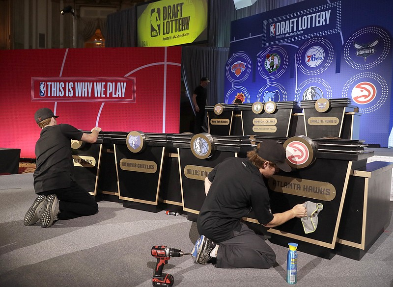 Stage hands prepare the set for the NBA basketball draft lottery Tuesday, May 15, 2018, in Chicago. (AP Photo/Charles Rex Arbogast)