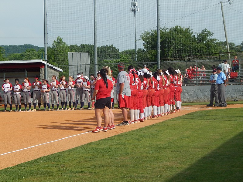 Ooltewah's Lady Owls, in all red, and Cookeville's Lady Cavaliers await the playing of the national anthem before their Region 3-AAA softball semifinal Monday at Ooltewah. The Lady Owls won 12-0.