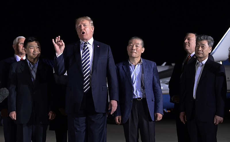 President Donald Trump speaks as he stands with the three Americans detained in North Korea for more than a year after they arrived at Andrews Air Force Base in Maryland last Thursday. Vice President Mike Pence, left, and Secretary of State Mike Pompeo, second from right, listen.