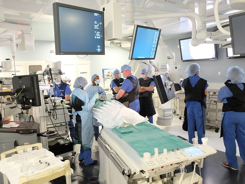 A team of CHI Memorial operating room personnel prepare for a midday Tuesday broncoscopy under the direction of Dr. Krish Bhadra, third from left. Two Vanderbilt University Medical Center doctors were in the hybrid operating room to observe and gain information on the latest techniques.