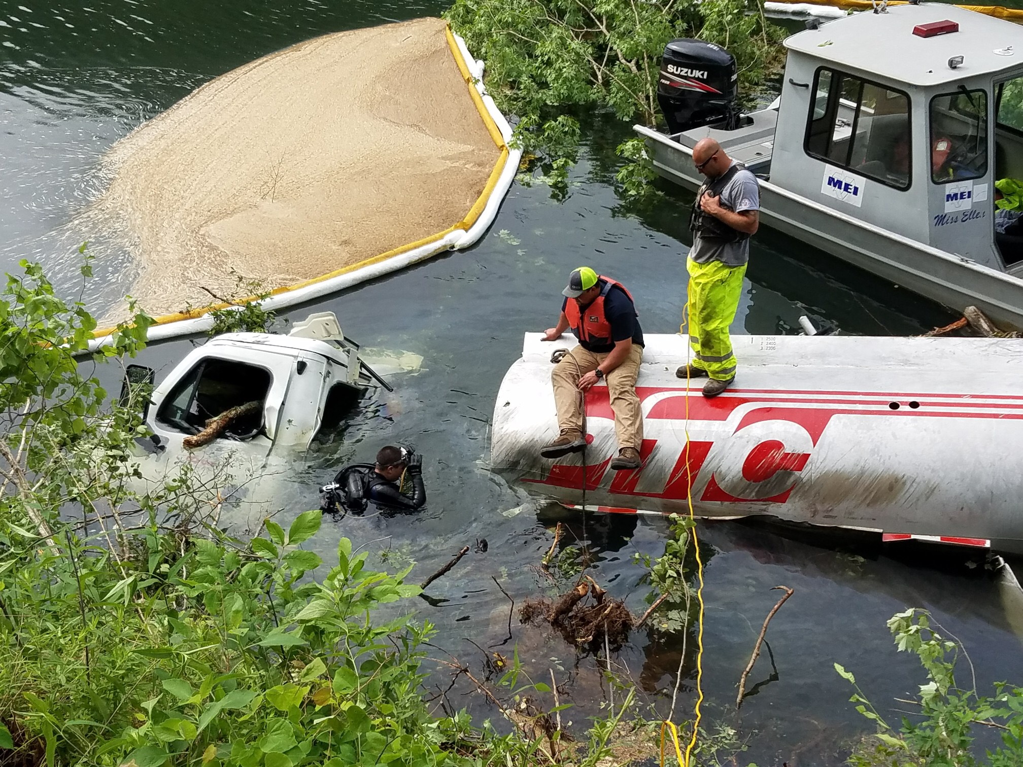 Divers are in the Ocoee River at the site of a diesel and gasoline spill after an 8,000-gallon tanker truck overturned into the water Tuesday evening on U.S. Highway 64.
(Photo by Polk County Sheriff's Office)