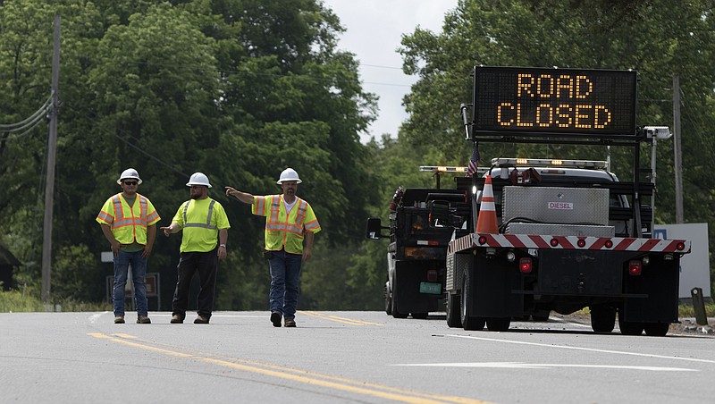 Workers reroute traffic away from the area where a tanker truck overturned into the Ocoee River in Polk County near the Tennessee Valley Authority Ocoee #1 dam on Wednesday, May 16, 2018, in Benton, Tenn.