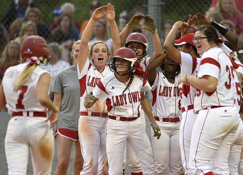 Staff Photo by Robin Rudd Ooltewah's Addy Keylon (7) is greeted by her teammates after she hit a three-run homerun. The Walker Valley Lady Mustangs visited the Ooltewah Lady Owls in the region softball championship on May 16, 2018