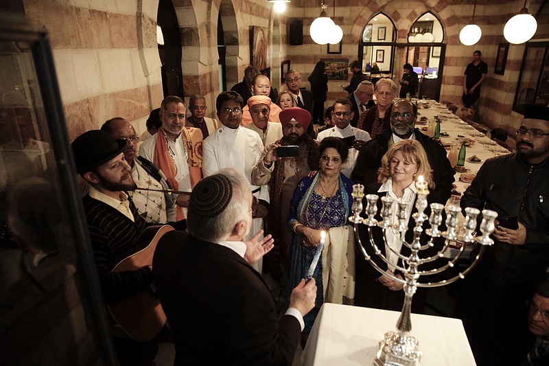 In this Dec. 12, 2017 file photo, an interfaith group from the Gulf state of Bahrain attend Hannukah candle lighting in Jerusalem. Arab states resoundingly condemned the killing of more than 50 Palestinians on Monday, May 14, 2018 in Gaza protests, just as they have after previous Israeli violence going back decades. But behind the scenes, fears over Iran have divided Arab leaders, with some willing to quietly reach out to Israel. Trump administration officials say a shift in alliances is already underway. (AP Photo/Mahmoud Illean, File)