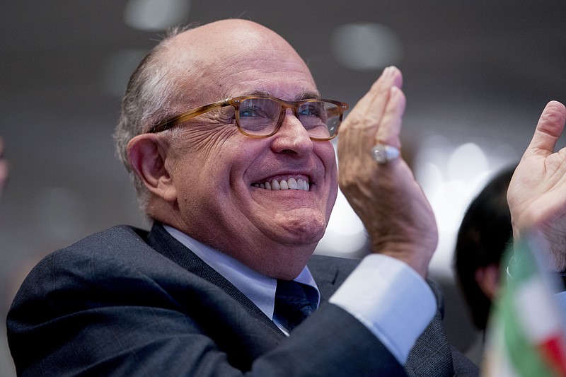 In this May 5, 2018 photo, Rudy Giuliani, an attorney for President Donald Trump, applauds at the Iran Freedom Convention for Human Rights and democracy at the Grand Hyatt in Washington. Giuliani's decision to join President Donald Trump's legal team could backfire on the former New York mayor if potential clients of his international consulting business view him as too erratic and go elsewhere for representation, according to legal experts. (AP Photo/Andrew Harnik)