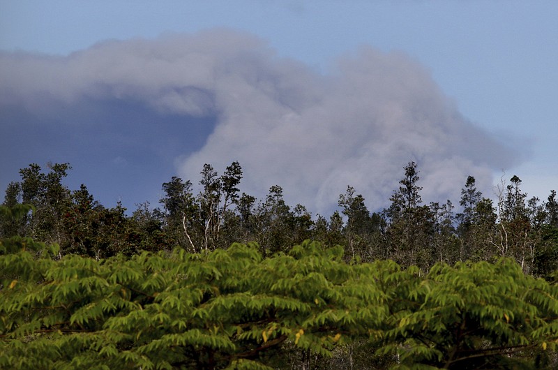 An ash plume rises over the summit of Kiluaea volcano, center, as seen from Pahoa, Hawaii, Tuesday, May 15, 2018. (AP Photo/Caleb Jones)