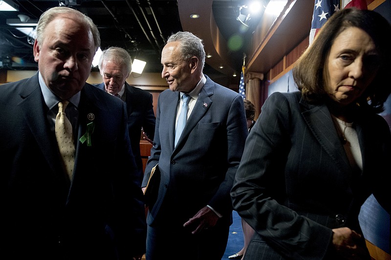 From left, Rep. Mike Doyle, D-Pa., Sen. Ed Markey, D-Mass., Senate Minority Leader Sen. Chuck Schumer of N.Y., and Sen. Maria Cantwell, D-Wash., leave a news conference on Capitol Hill in Washington, Wednesday, May 16, 2018, after the Senate passed a resolution to reverse the FCC decision to end net neutrality. (AP Photo/Andrew Harnik)