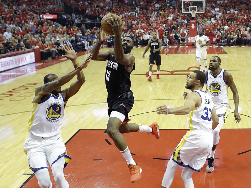 Houston Rockets guard James Harden (13) drives to the basket past Golden State Warriors defenders Andre Iguodala (9), Stephen Curry (30), and Kevin Durant (35) during the first half in Game 2 of the NBA basketball Western Conference Finals, Wednesday, May 16, 2018, in Houston. (AP Photo/David J. Phillip)