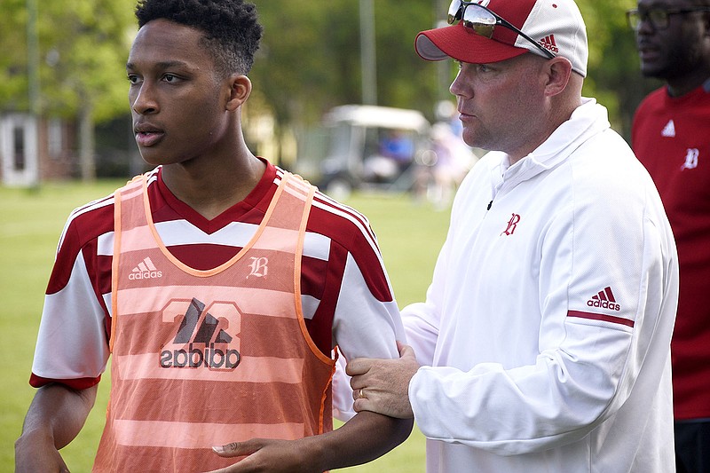 Dee Appleberry talks with Baylor boys' soccer coach Curtis Blair before entering a game at McCallie last month. Blair is excited the Red Raiders are headed back to the state tournament for the first time in three years after beating Briarcrest 2-0 on Thursday night in a quarterfinal.