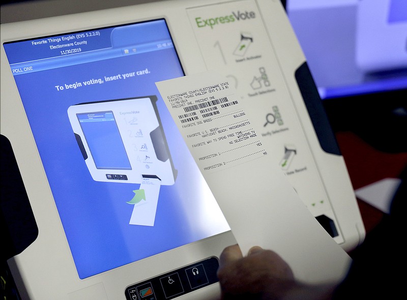 FILE - This Oct. 19, 2017, file photo shows a new voting machine which prints a paper record on display at a polling site in Conyers, Ga.